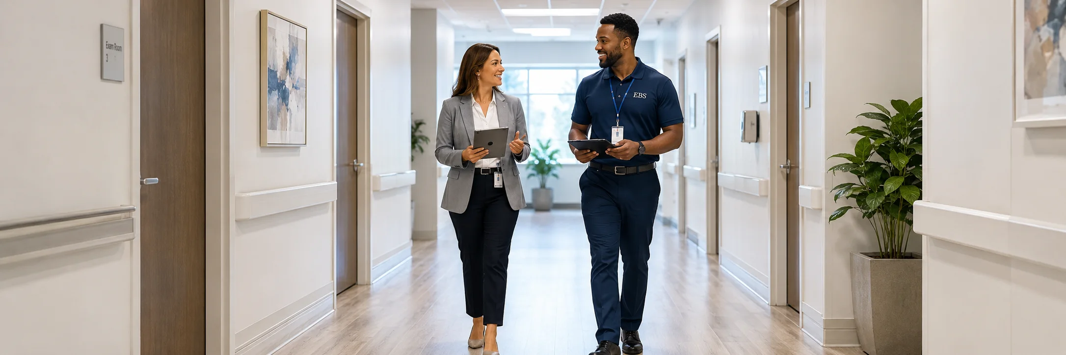 EBS representative walking a medical office hallway during a healthcare janitorial walkthrough